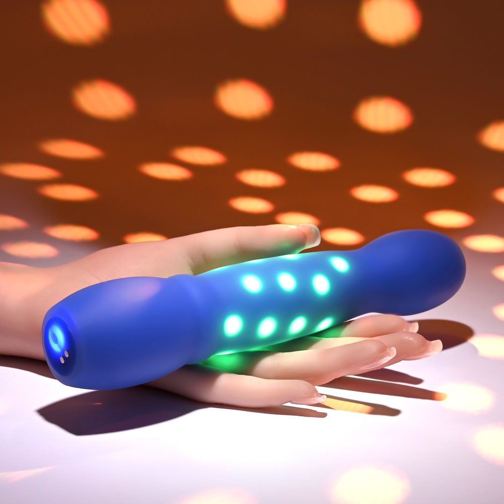 Evolved DISCO DIVA - 20.9 cm USB Rechargeable Light Up Vibrator glowing in hand with colorful lights.