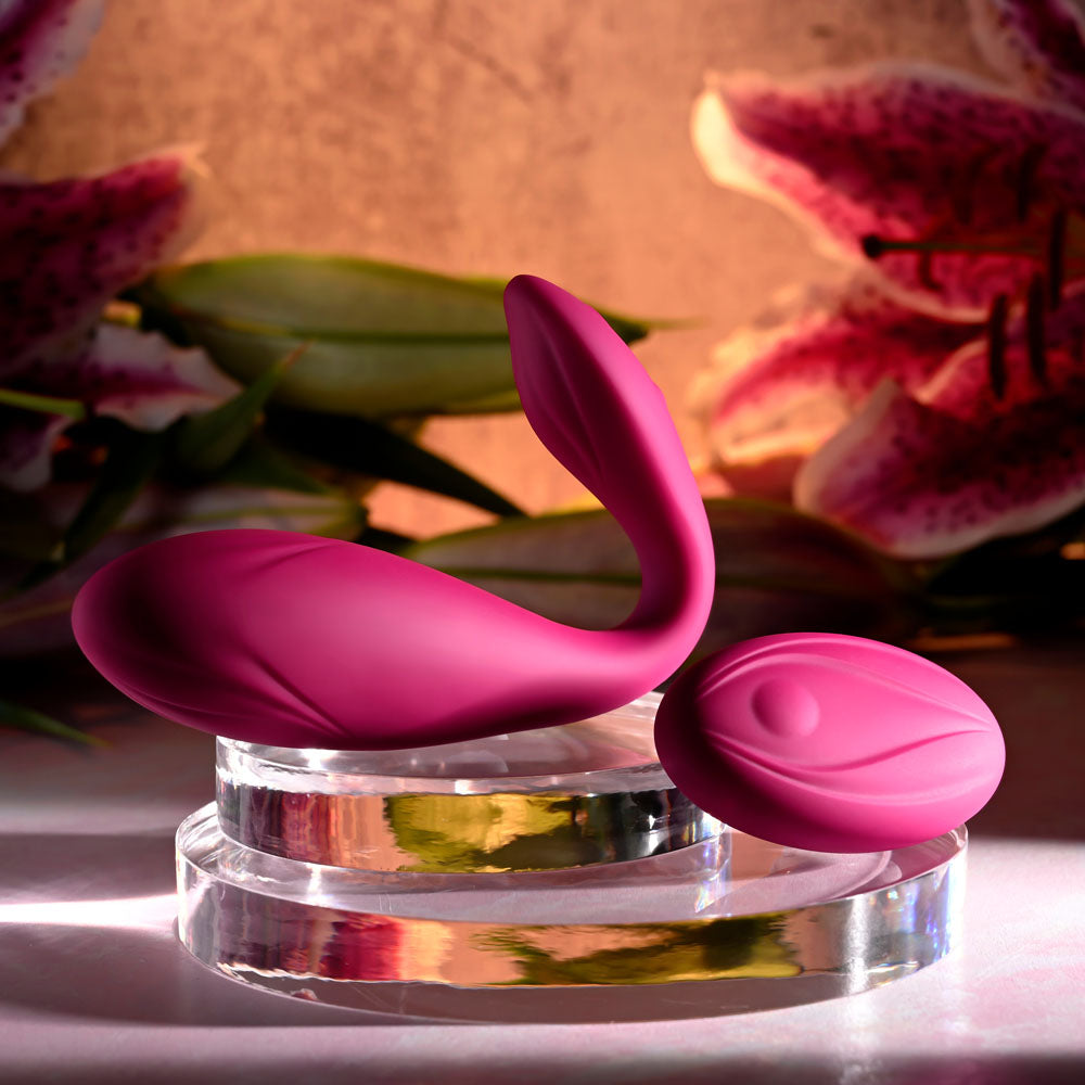 Evolved CHERRY POSE - 16.1 cm USB Rechargeable Flexible & Posable Vibrator with Remote on display with floral backdrop.