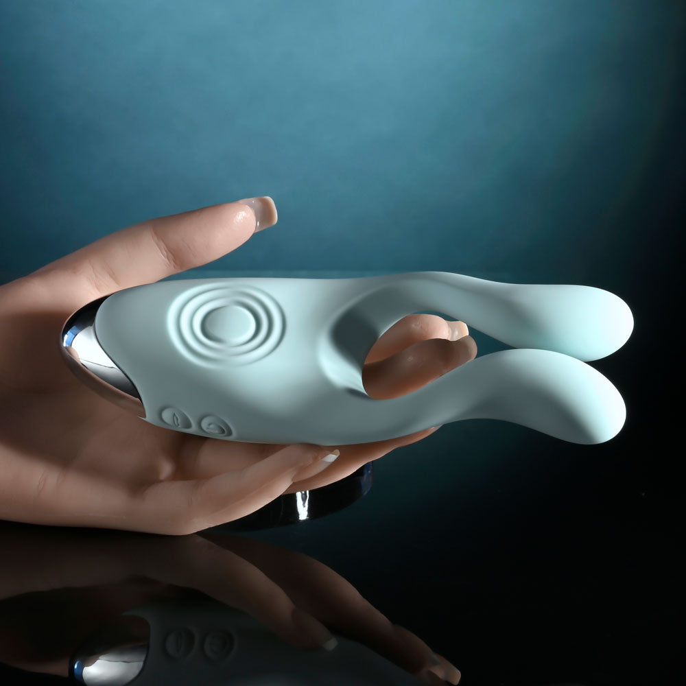 Evolved COUPLES THERAPY - Teal USB Rechargeable Couples Stimulator in a hand for intimate essentials.