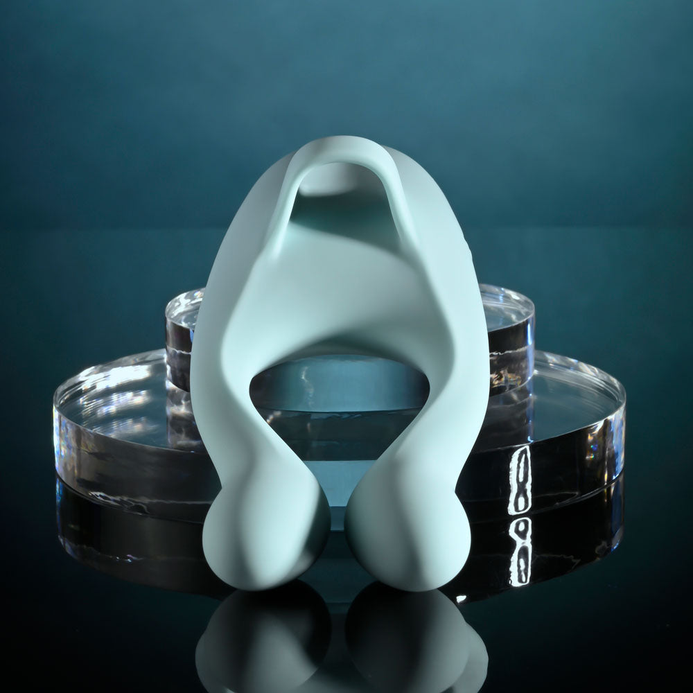Evolved COUPLES THERAPY - Teal USB Rechargeable Couples Stimulator on display with soft lighting effect.