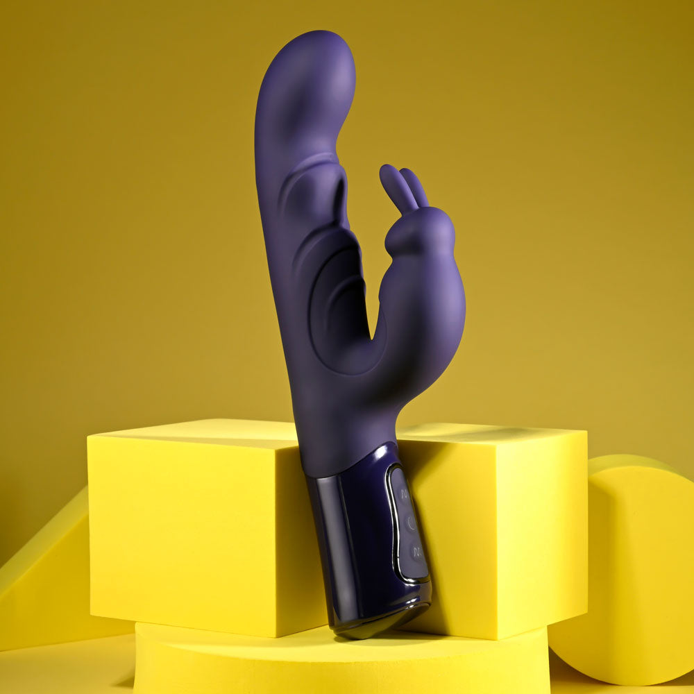 Evolved BIG DEAL - 25.7 cm USB Rechargeable Rabbit Vibrator on yellow geometric shapes.