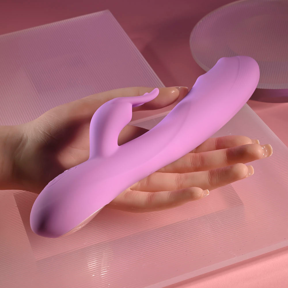 Evolved BEAD THE WAY -  23.2 cm USB Rechargeable Rabbit Vibrator displayed in a hand on a pink background.