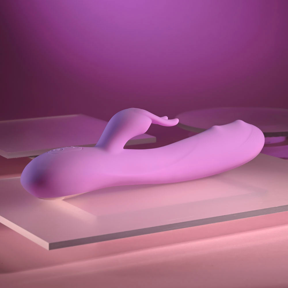 Evolved BEAD THE WAY - 23.2 cm USB Rechargeable Rabbit Vibrator on a pink background.