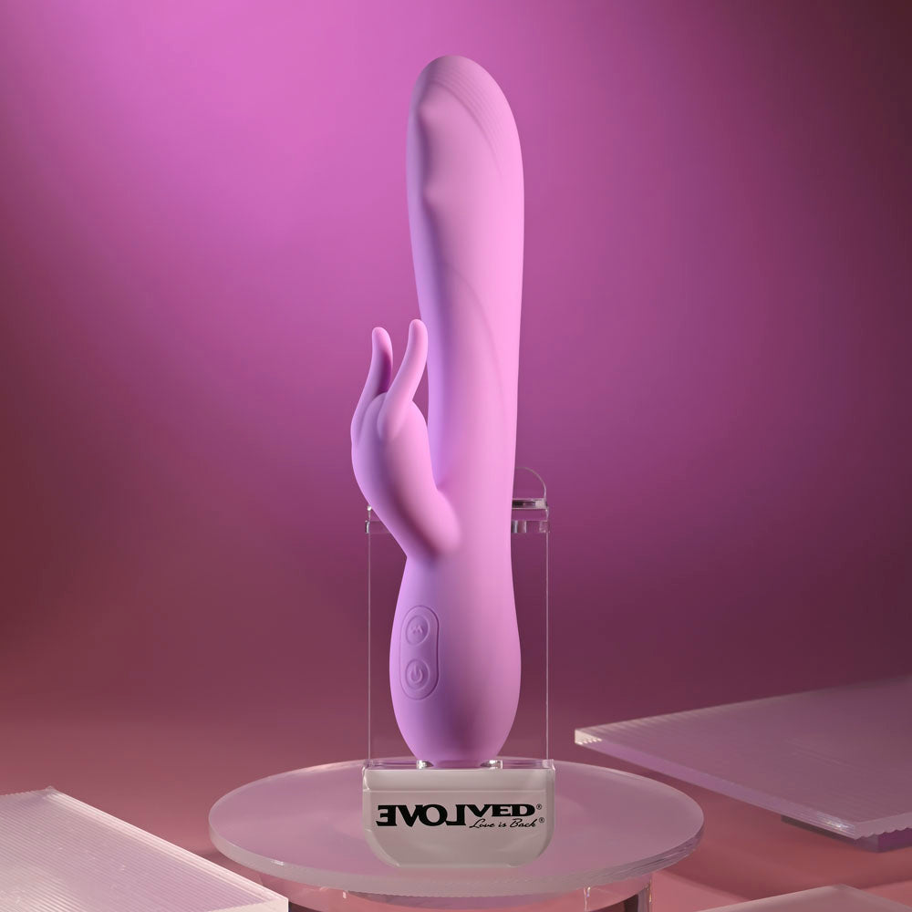 Evolved BEAD THE WAY -  23.2 cm USB Rechargeable Rabbit Vibrator displayed on a sleek pedestal against a pink background.
