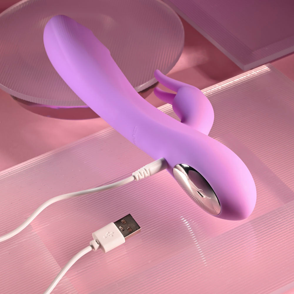 Evolved BEAD THE WAY - 23.2 cm USB Rechargeable Rabbit Vibrator with charging cable on a pink background.