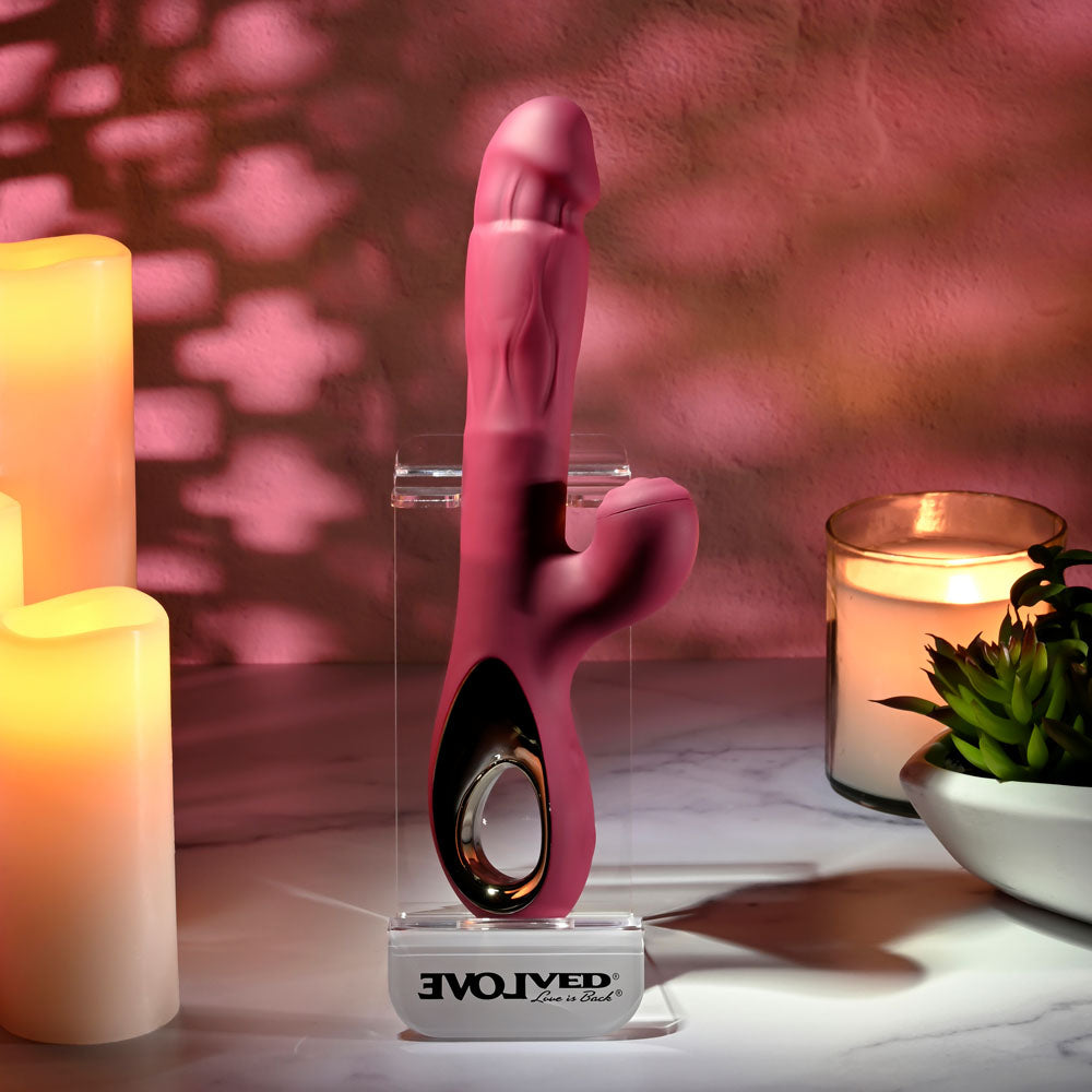 Evolved BURSTING WITH PLEASURE - 25.4 cm USB Rechargeable Vibrator with Tapping Clitoral Stimulator against candles and plants.