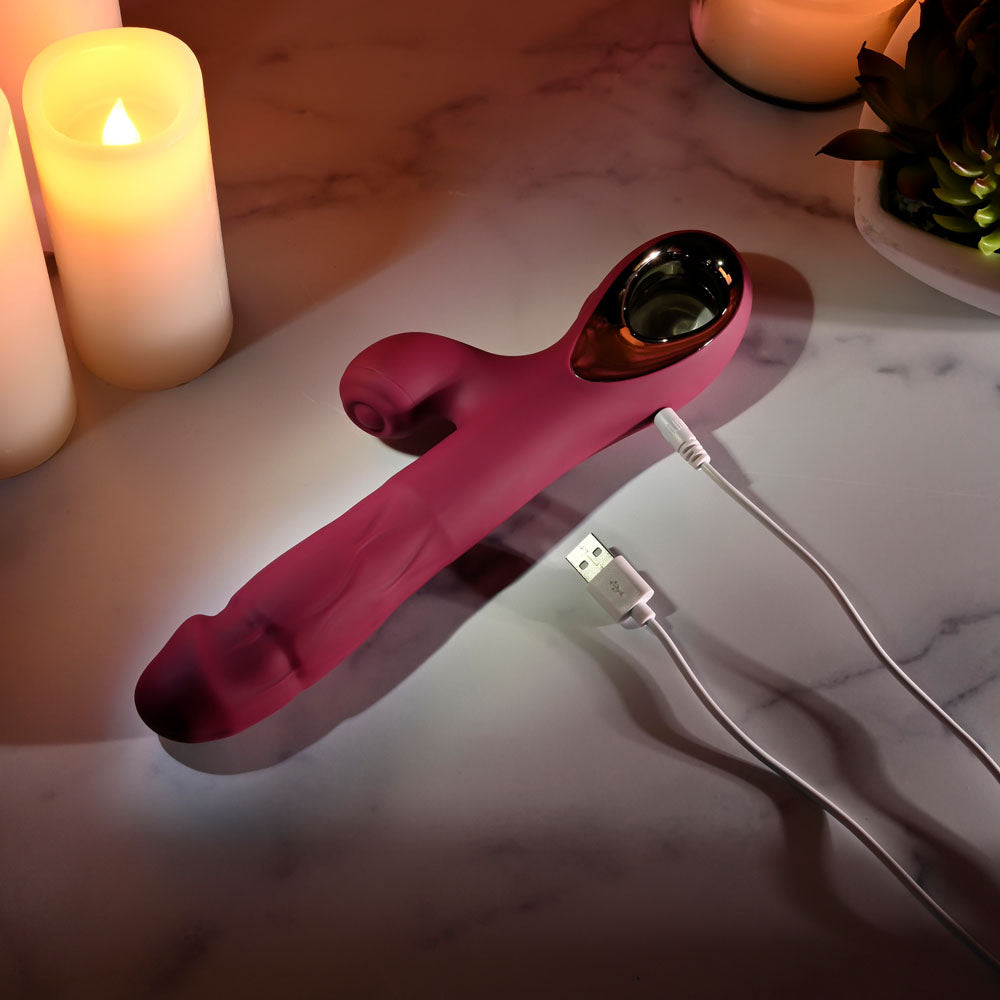 Evolved BURSTING WITH PLEASURE - 25.4 cm USB Rechargeable Vibrator with Tapping Clitoral Stimulator on a marble surface.