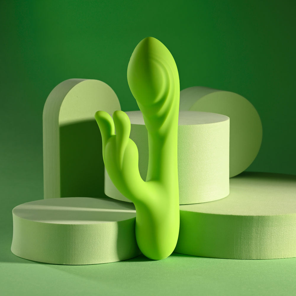 Evolved BRAT BUNNY - 16.2 cm USB Rechargeable Rabbit Vibrator on green background.