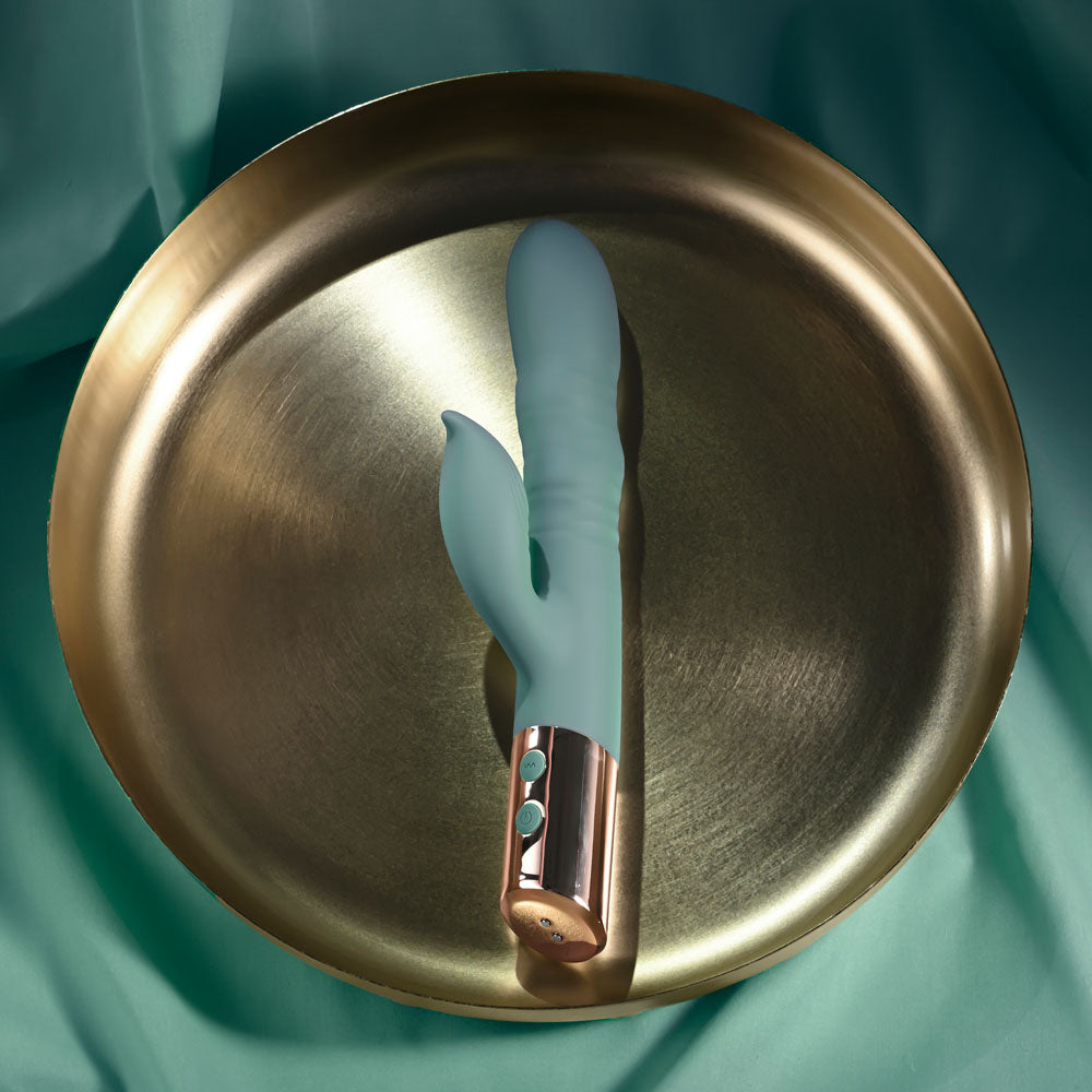 Evolved THE SHIMMY -  USB Rechargeable Thrusting Rabbit Vibrator resting on a stylish gold tray.