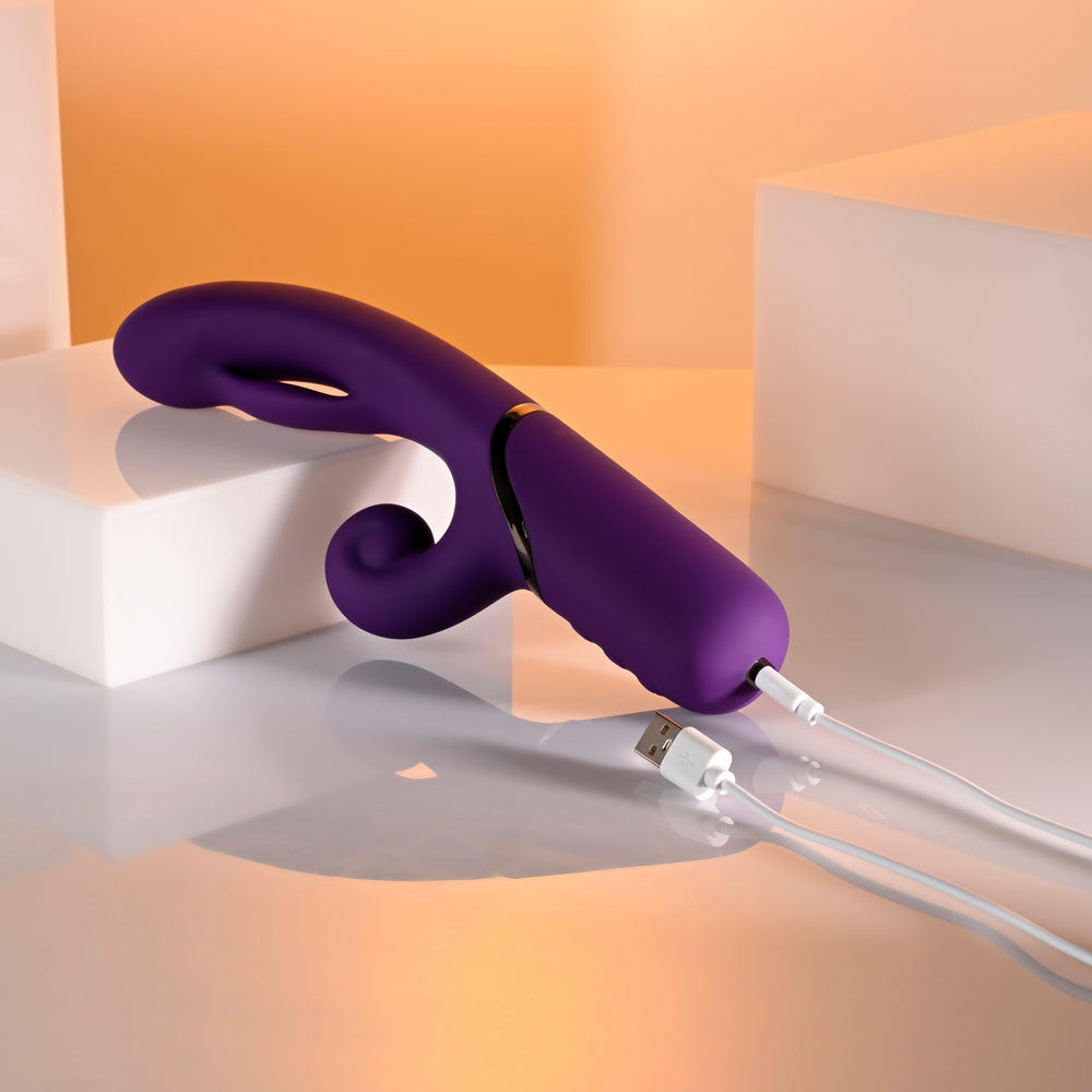 Evolved PLEASURE PUFF - 24.1 cm USB Rechargeable Inflatable Rabbit Vibrator charging on a sleek surface.