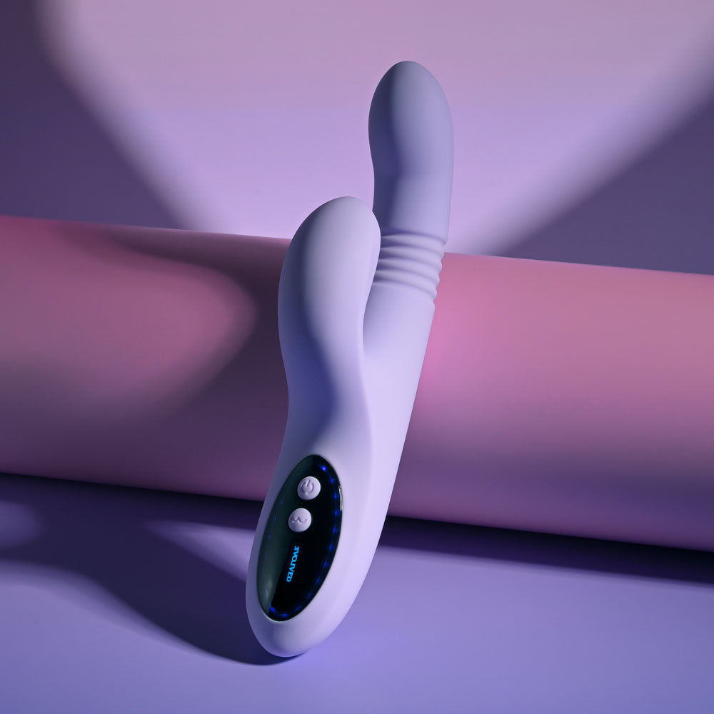 Evolved PEP TALK - 23.3 cm USB Rechargeable Thrusting Vibrator with Tapping Clitoral Stimulator on a soft background.