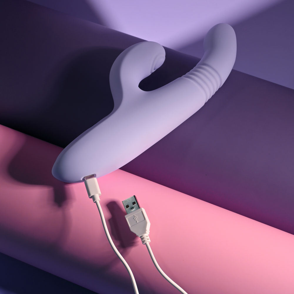 Evolved PEP TALK -  23.3 cm USB Rechargeable Thrusting Vibrator with Tapping Clitoral Stimulator on a colored background.