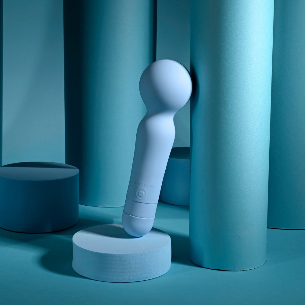 Evolved IRIS -  18.3 cm USB Rechargeable Massage Wand on a blue background, showcasing its sleek design and soft silicone material.