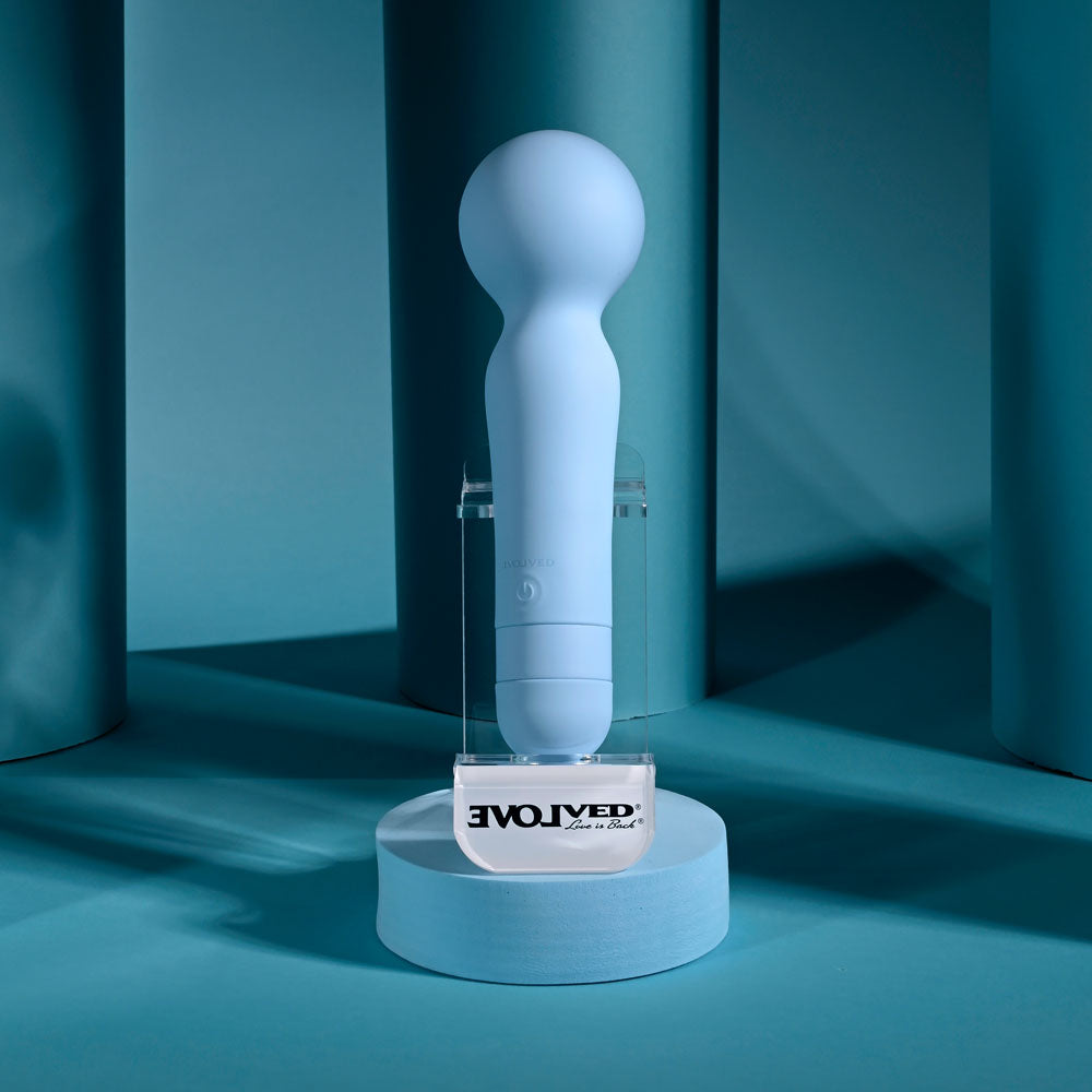 Evolved IRIS -  18.3 cm USB Rechargeable Massage Wand displayed on a pedestal with a blue backdrop.