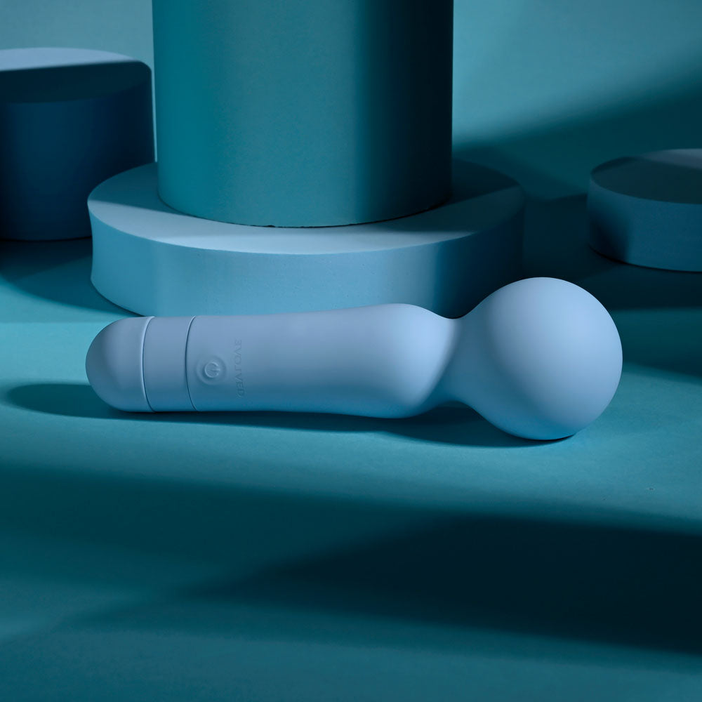 Evolved IRIS - 18.3 cm USB Rechargeable Massage Wand on a blue background, showcasing its soft silicone design.