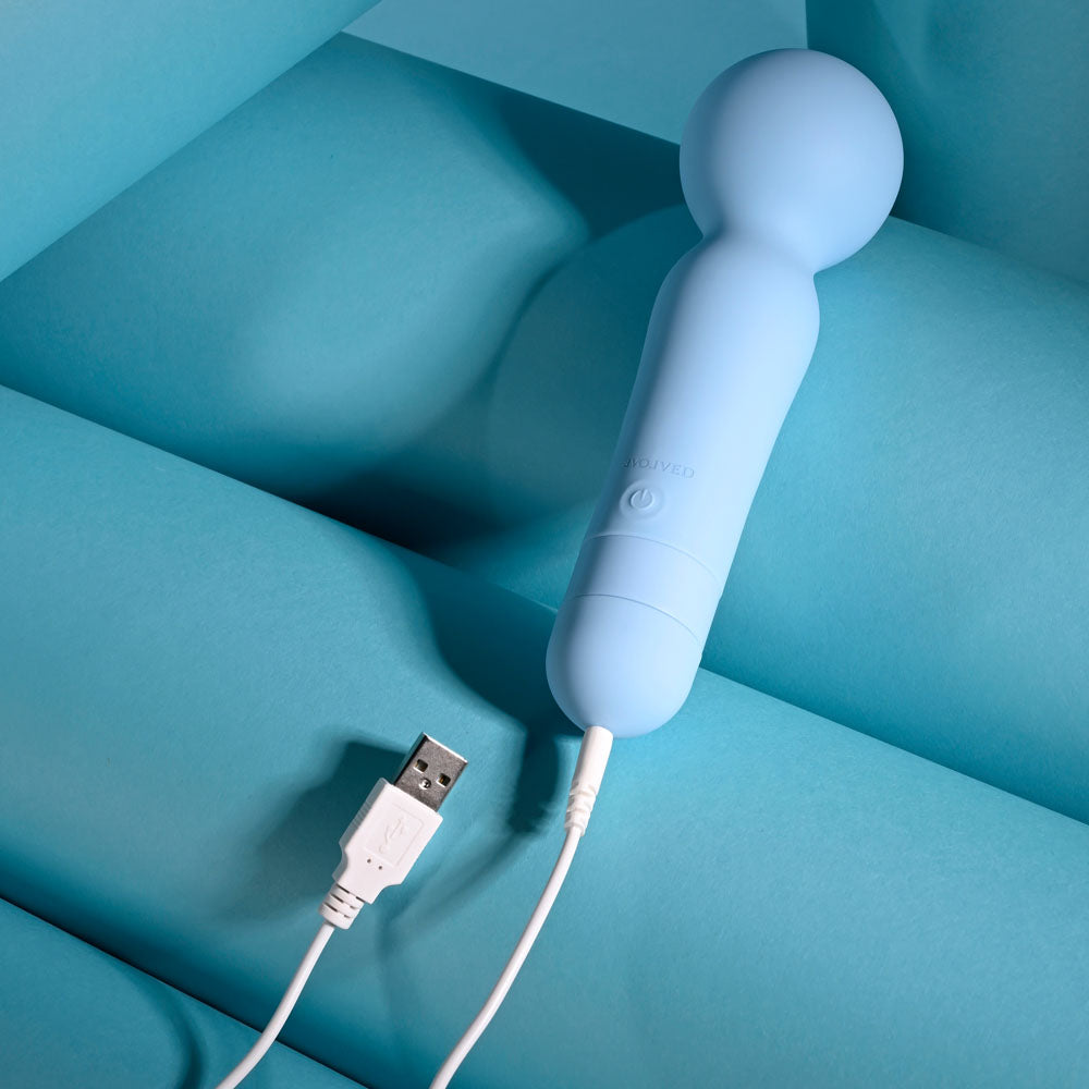 Evolved IRIS - 18.3 cm USB Rechargeable Massage Wand charging on a blue background, perfect for intimate essentials for her.