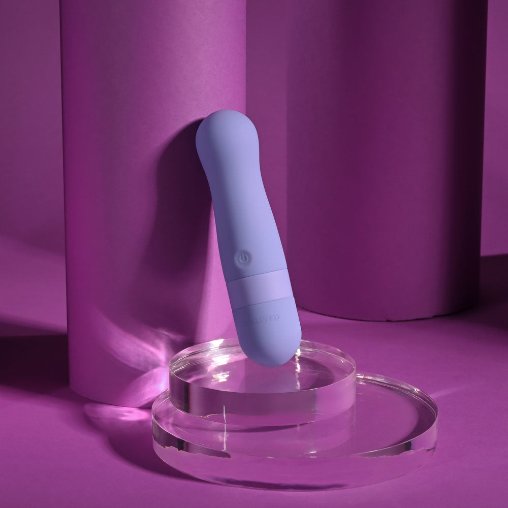 Evolved SQUISHY BULLET - 11 cm USB Rechargeable Bullet resting on a clear surface with a purple backdrop.