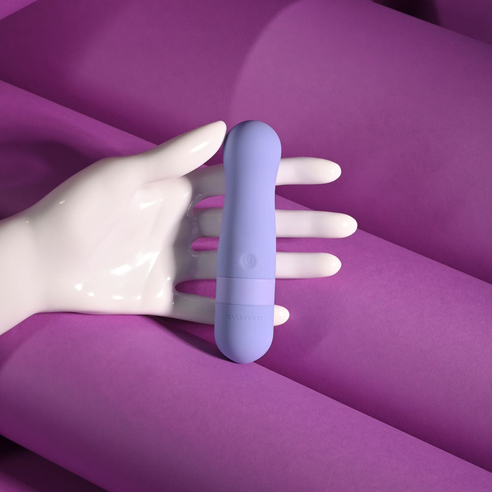 Evolved SQUISHY BULLET - 11 cm USB Rechargeable Bullet held in a hand with purple background, intimate essentials for her.