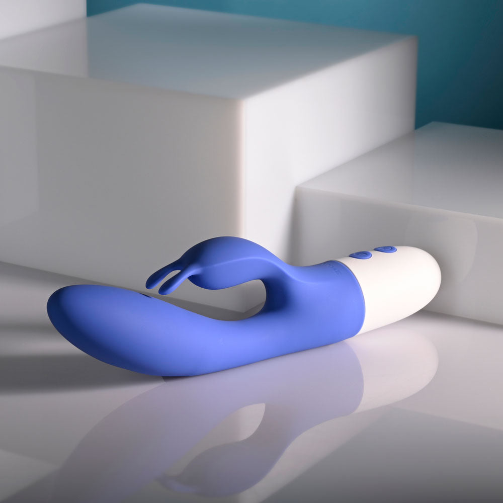 Evolved FUNNY BUNNY - 20 cm USB Rechargeable Rabbit Vibrator on a reflective surface.