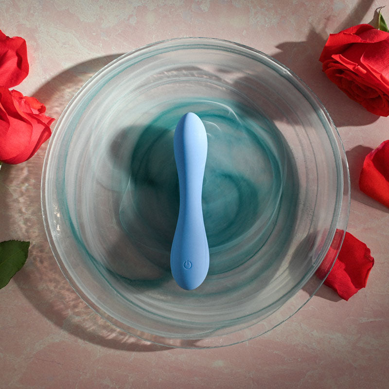 Evolved  CRUSH -  12 cm USB Rechargeable Mini Vibrator on a decorative plate surrounded by red roses.