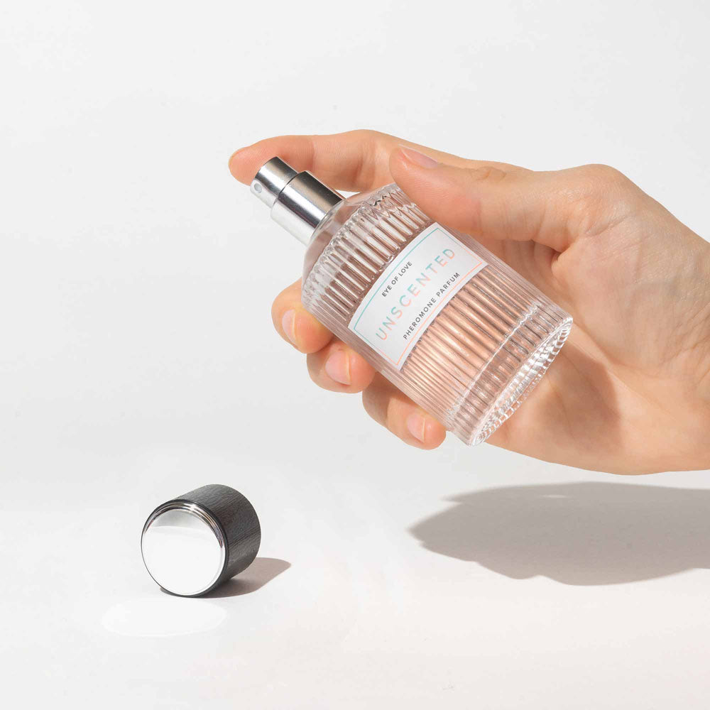 Eye Of Love Unscented Pheromone Perfume - 50 ml - Unisex Pheromone Perfume - 50 ml Spray in hand with cap beside.