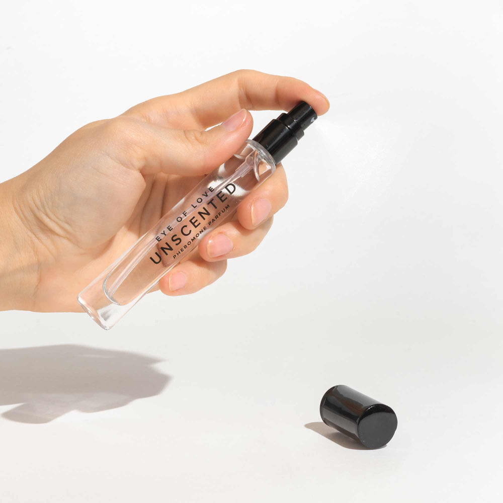 Hand holding Eye Of Love Unscented Pheromone Perfume - 10 ml - Unscented Pheromone Cologne for Men to attract Women - 10 ml Spray.