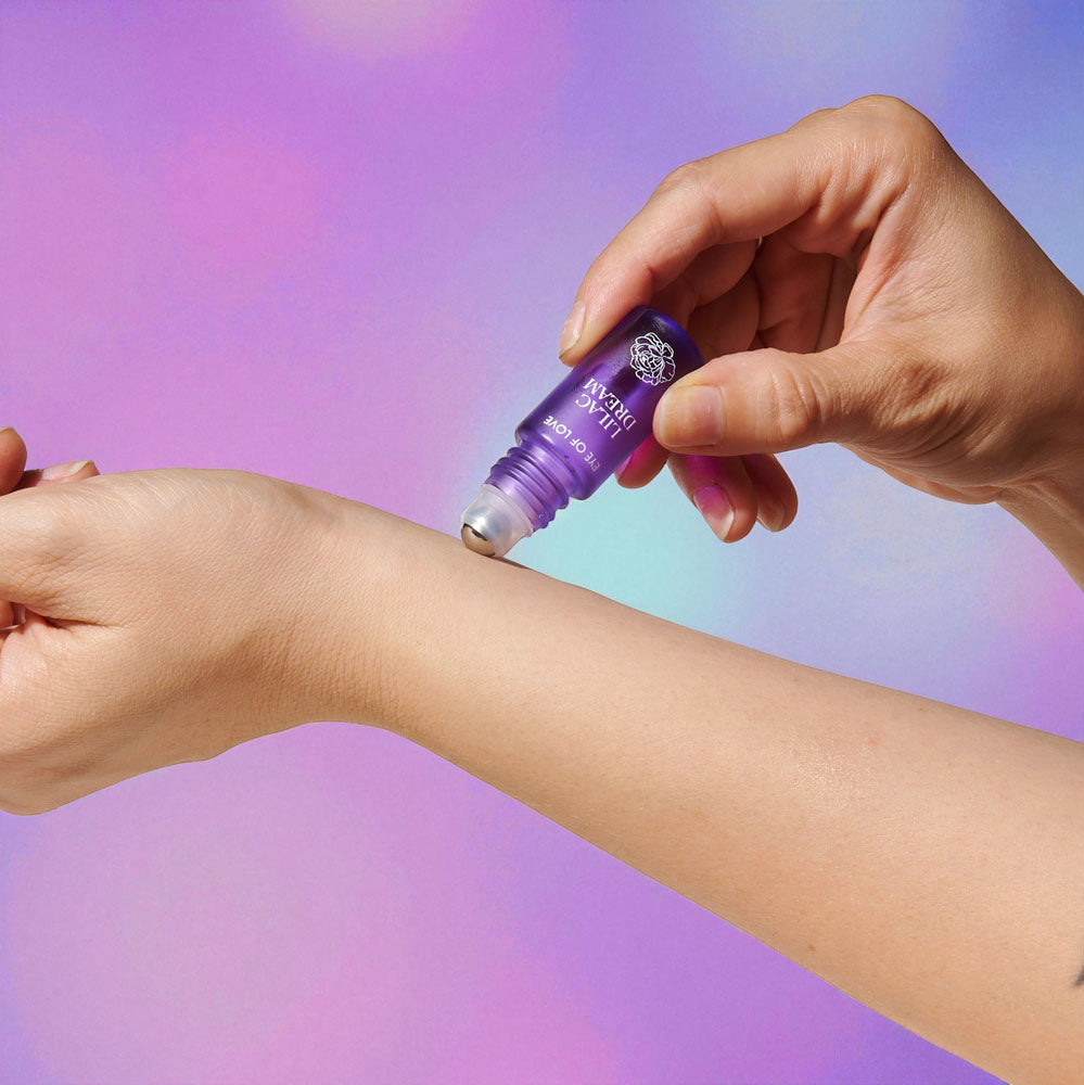 Applying Eye Of Love Love In Bloom Pheromone Perfume Roll-On Set - Day to Night (Sunny Daze & Lilac Dream) Pheromone Perfume Oils for Women to attract Men - 10 ml Roll On Bottles