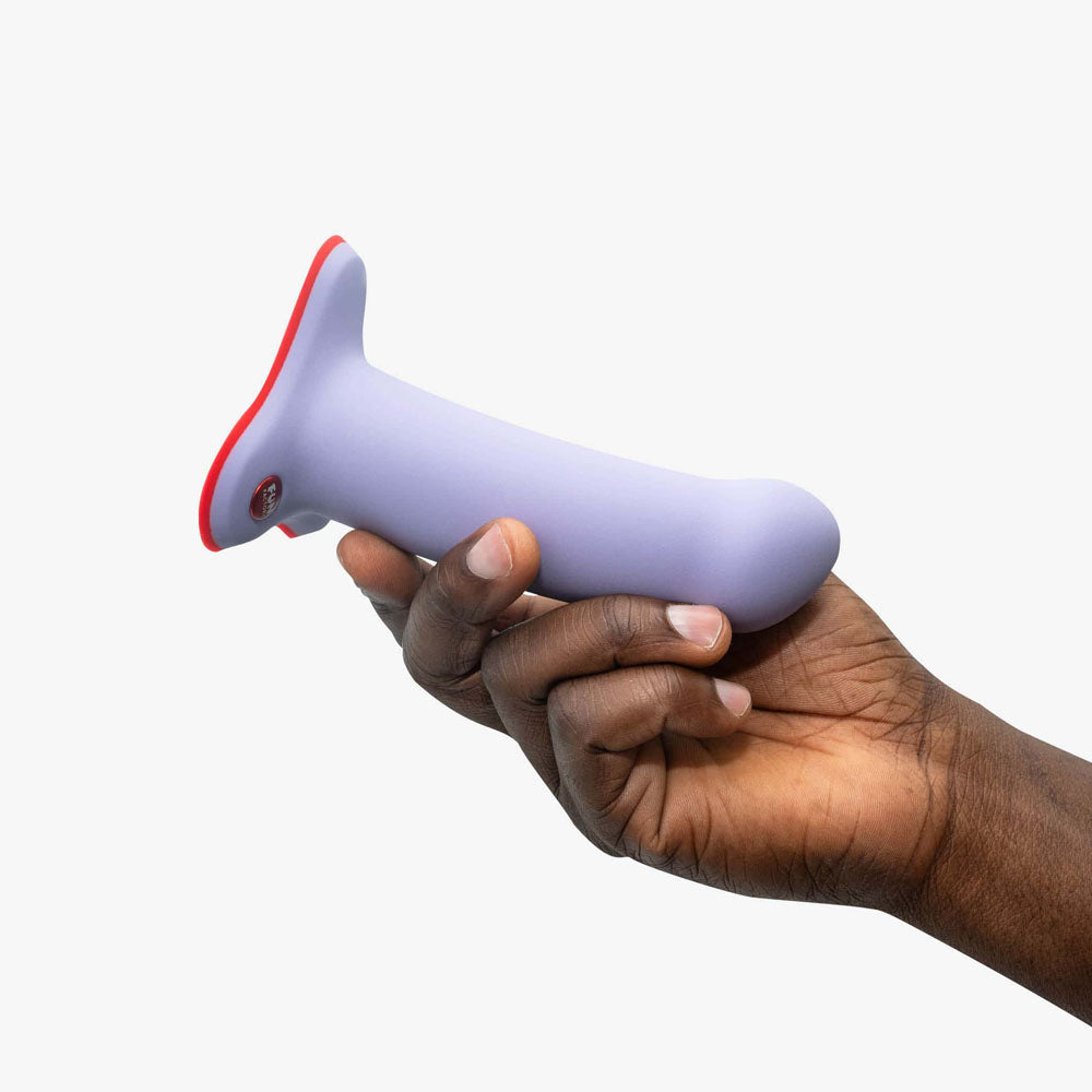 Fun Factory AMOR lavender - Lavender 14.6 cm Dildo held in hand, showcasing its sleek design and body-safe materials.
