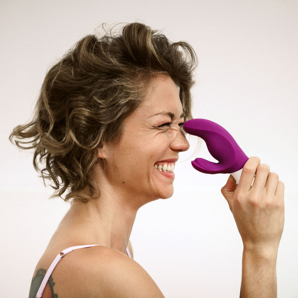 Fun Factory MISS BI grape - Grape 17 cm USB Rechargeable Rabbit Vibrator in a woman's hand, showcasing its playful design.