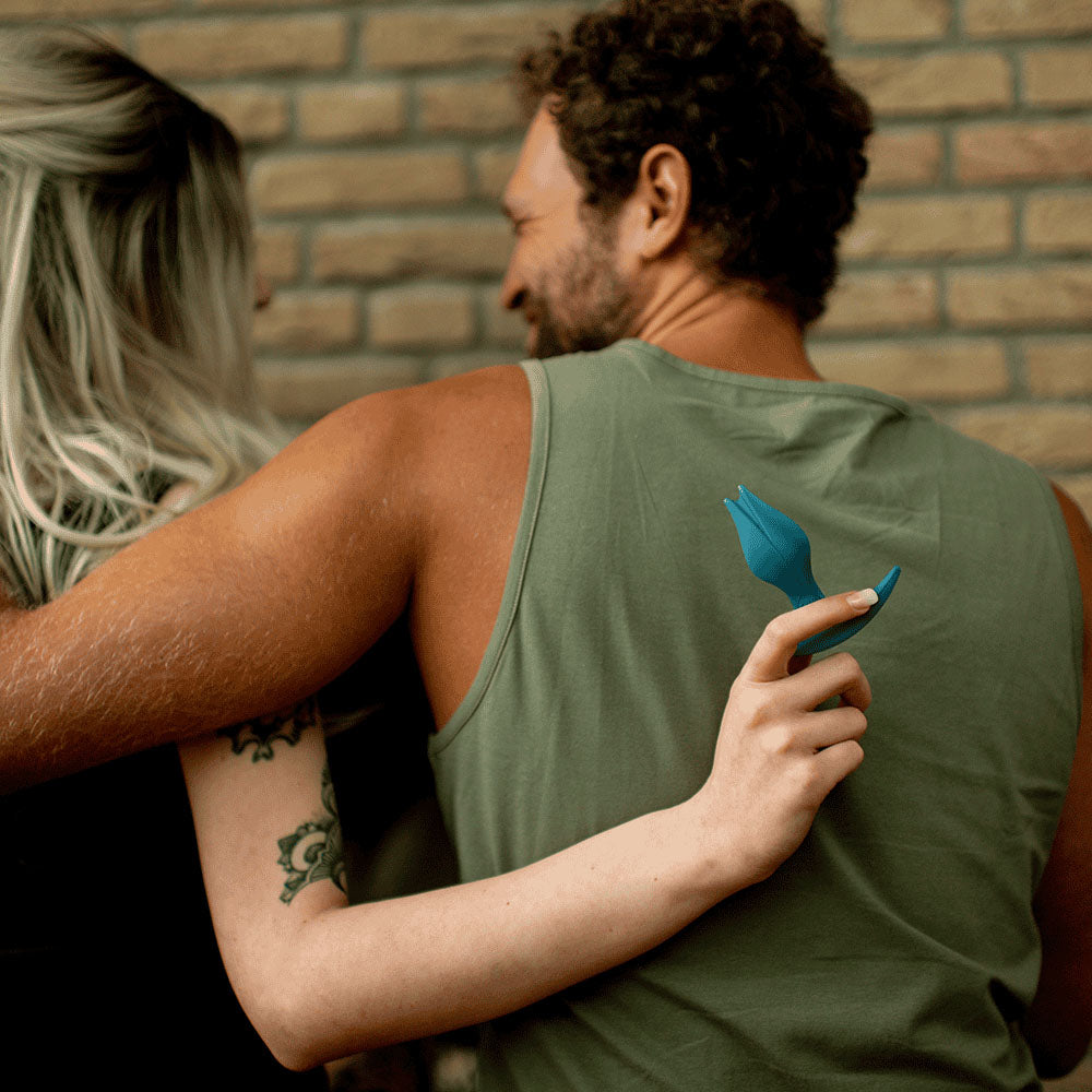 Fun Factory BOOTIE FEM Bottle - Bottle  8.5 cm Butt Plug held by a couple in a playful embrace.