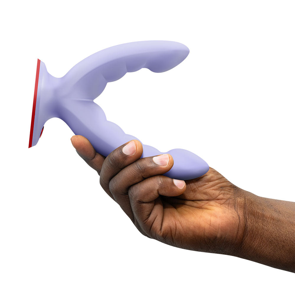 Fun Factory RYDE - Grinding Dildo held in hand, featuring ridged shaft and suction base for stimulating pleasure.