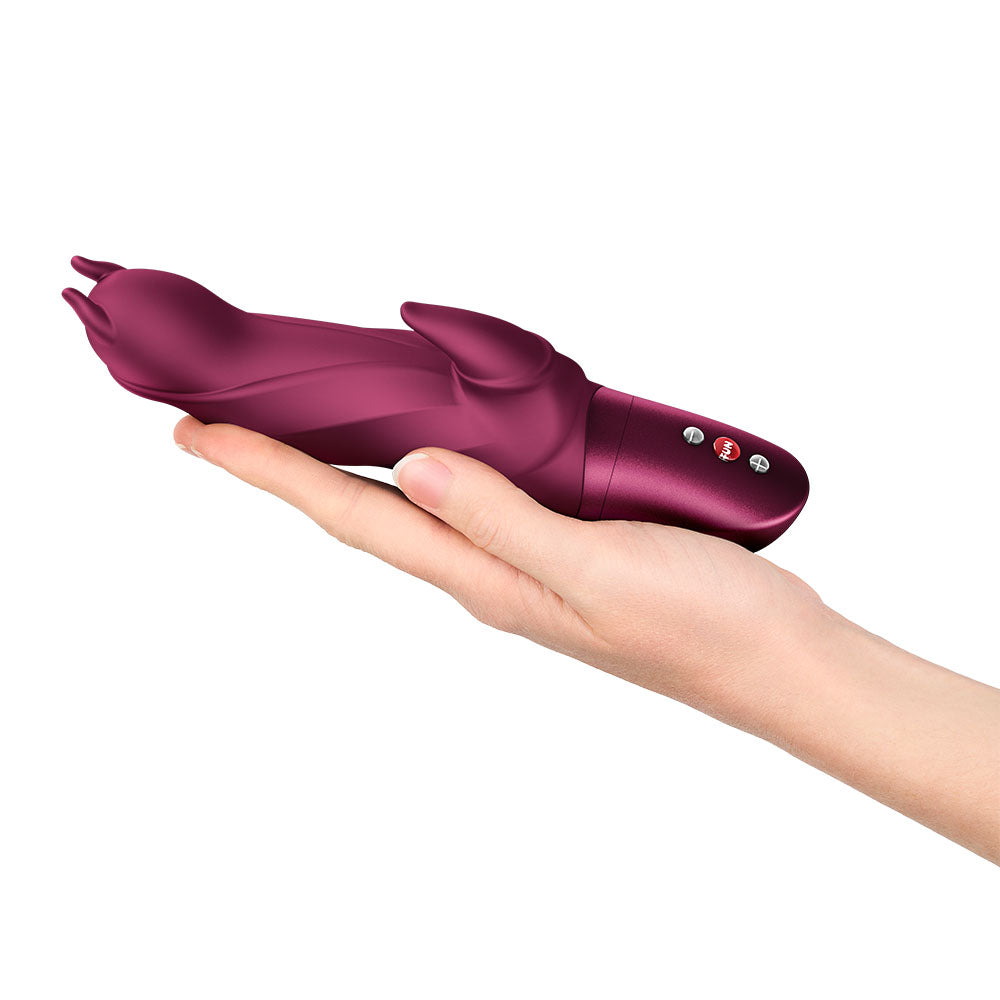 Fun Factory DARLING DEVIL Wine - Wine 20 cm Vibrator held in hand, showcasing its design and features.