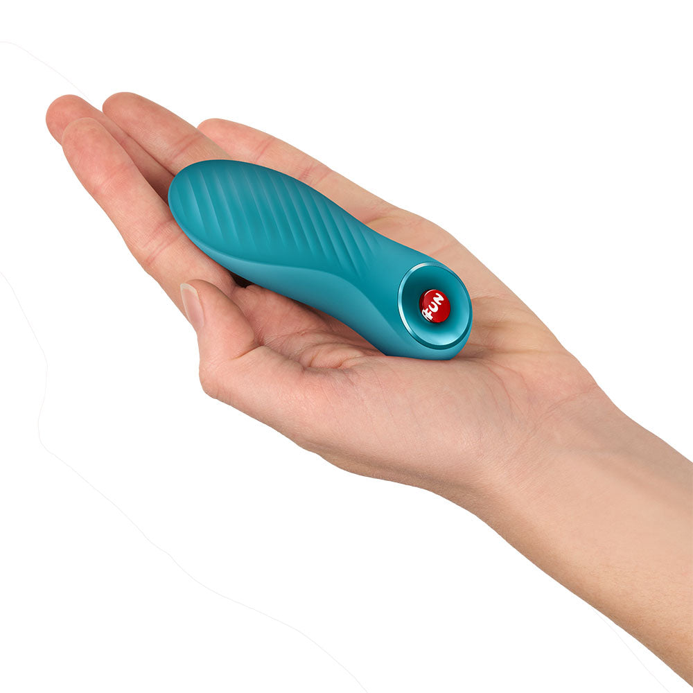 Fun Factory BIJOU Aquamarine - Aquamarine USB-C Rechargeable Stimulator held in a hand, showcasing its compact design.