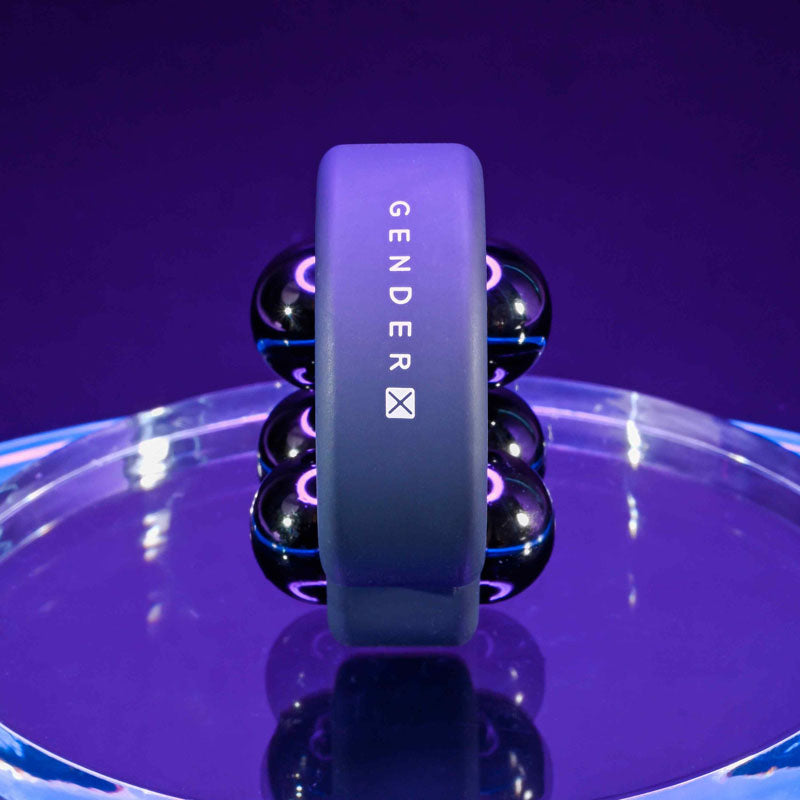 Gender X WORKOUT RING -  Weighted Cock Ring displayed on a shiny surface with removable steel weights.
