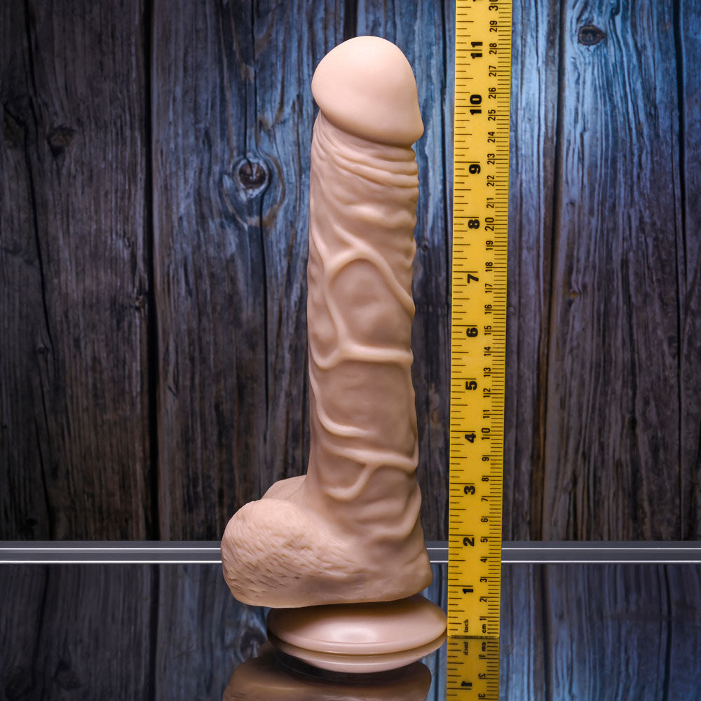 Gender X 10'' FLEXSKIN POSEABLE TRUE FEEL - Light - 29.2 cm Poseable Dong displayed beside a ruler on a reflective surface.