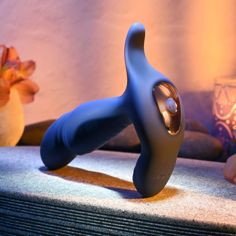 Gender X TRUE -  13.5 cm USB Rechargeable Thrusting Prostate Massager on a stone surface with a soft glow.