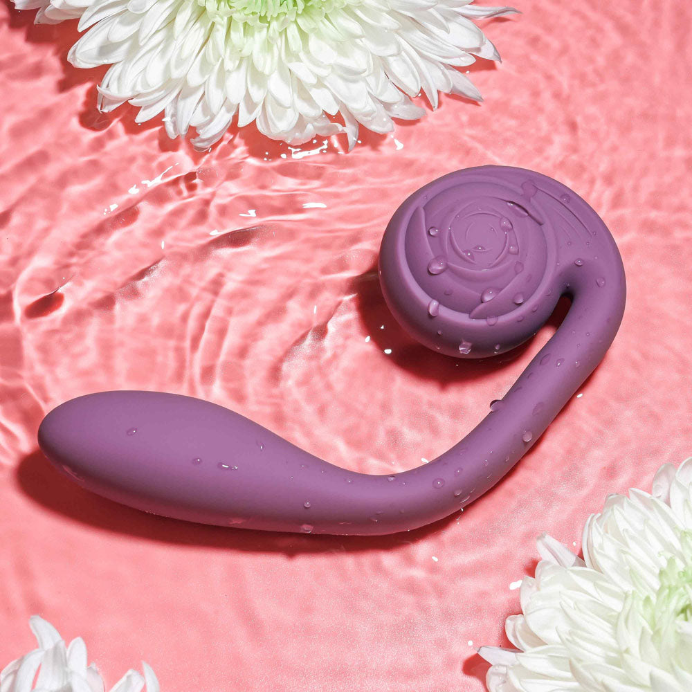 Gender X POSEABLE YOU -  USB Rechargeable Poseable Vibrator in water with flowers, featuring smooth silicone design.