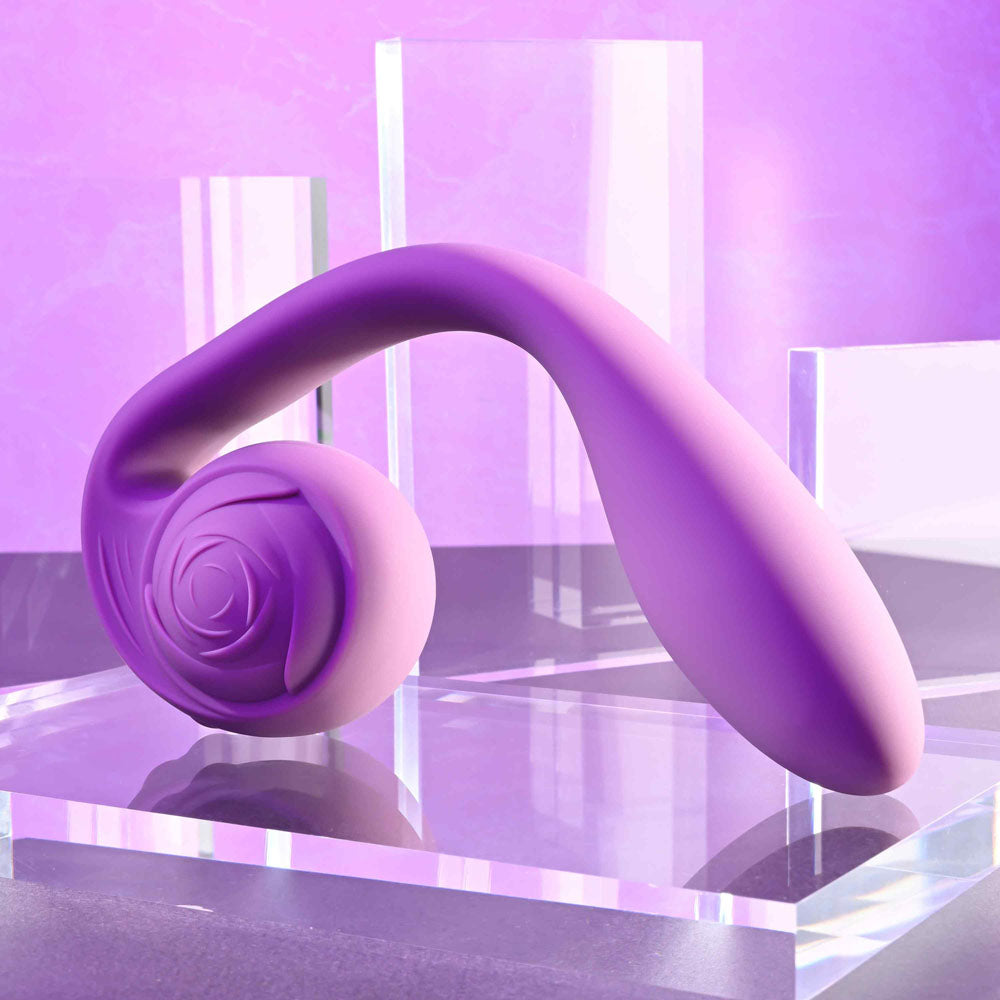 Gender X POSEABLE YOU - USB Rechargeable Poseable Vibrator displayed on a clear pedestal with a purple backdrop.