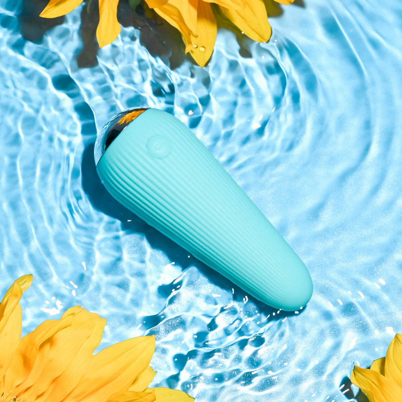 Gender X O-CONE -  10.8 cm (4.25'') USB Rechargeable Bullet in water surrounded by yellow flowers.
