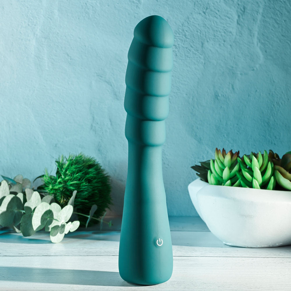 Gender X SCORPION - 21.2 cm USB Rechargeable Vibrator in teal with ribbed shaft against a serene background.