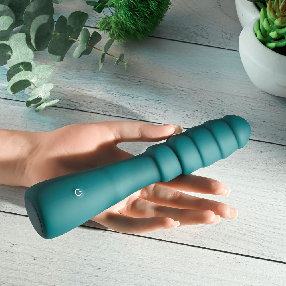 Gender X SCORPION -  21.2 cm USB Rechargeable Vibrator in hand, showcasing ribbed silicone design.