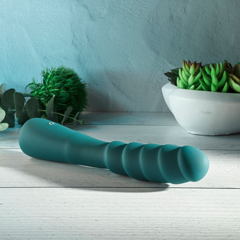 Gender X SCORPION -  21.2 cm USB Rechargeable Vibrator displayed among greenery.