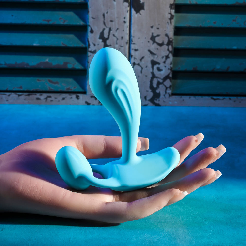 Gender X WEAR ME OUT -  11.1 cm USB Rechargeable Wearable Vibrator with Wireless Remote held in a hand.