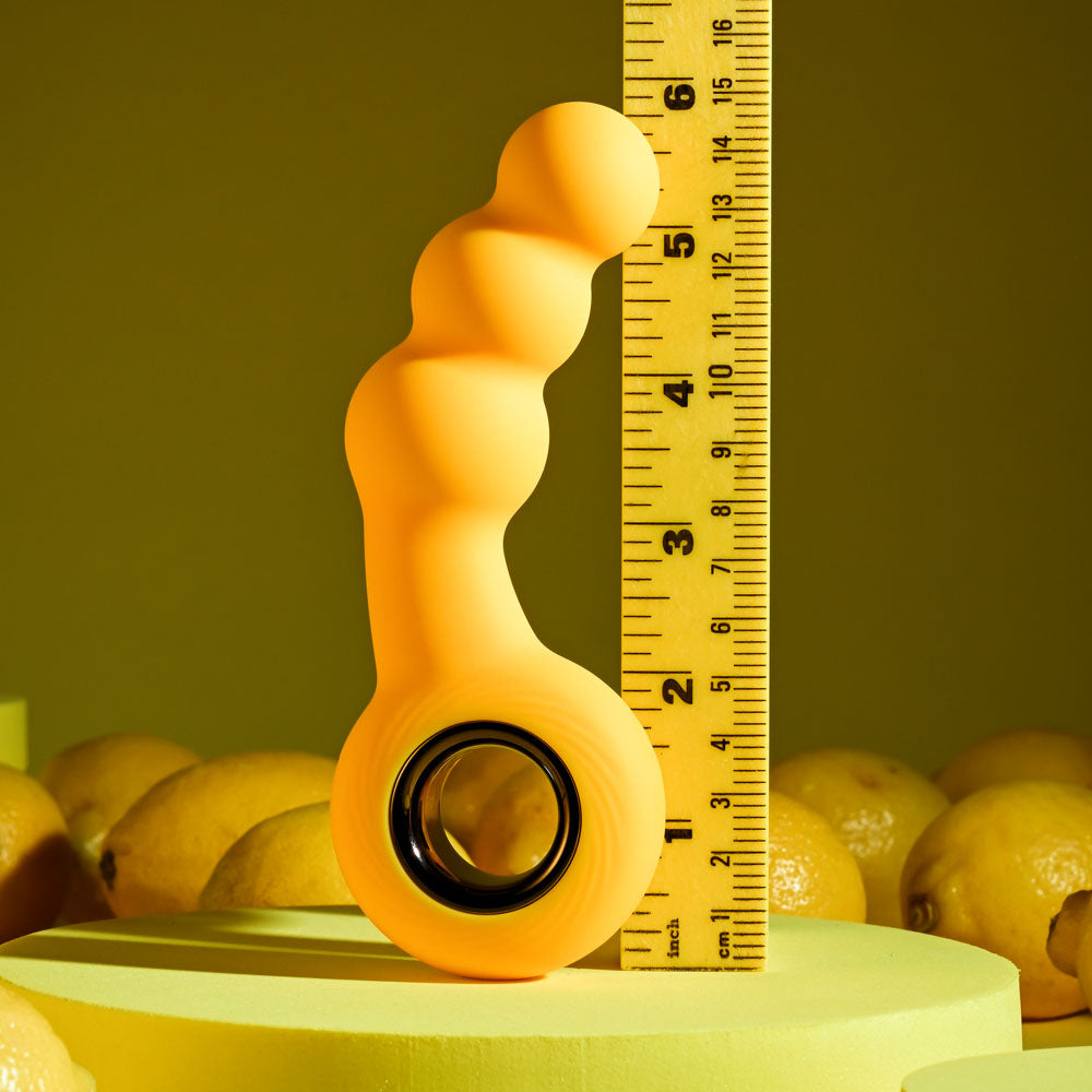 Gender X BUMBLE - 14.9 cm USB Rechargeable Butt Plug next to a ruler on yellow background with lemons.