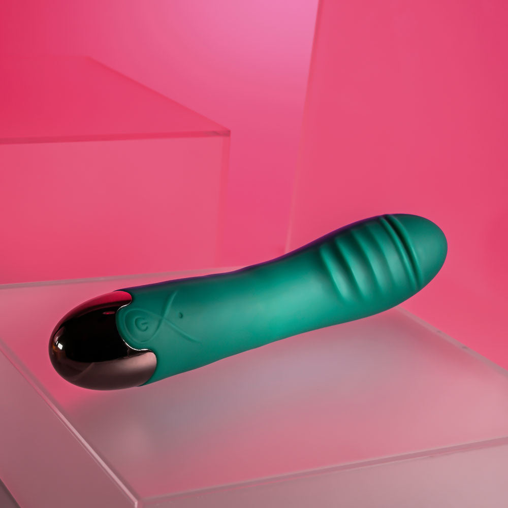 Gender X PIROUETTE - 20.6 cm USB Rechargeable Vibrator against a pink backdrop, showcasing its sleek design.