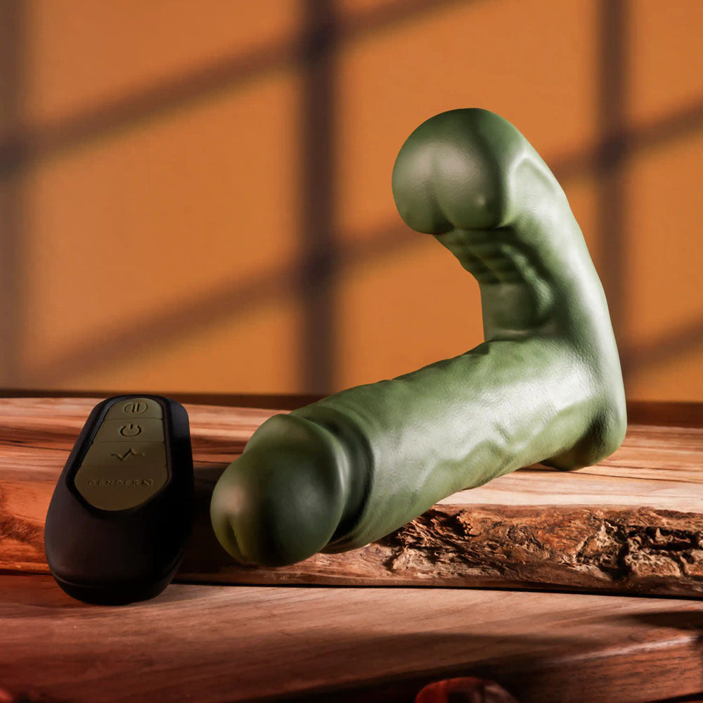 Gender X THE HUNK - 15.2 cm USB rechargeable thrusting vibrator with remote on a wooden surface.