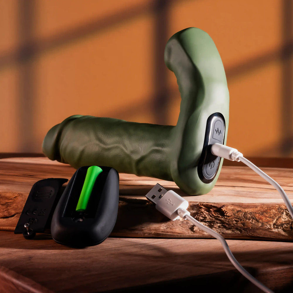 Gender X THE HUNK - 15.2 cm USB Rechargeable Thrusting Vibrator with Remote on a wooden surface.