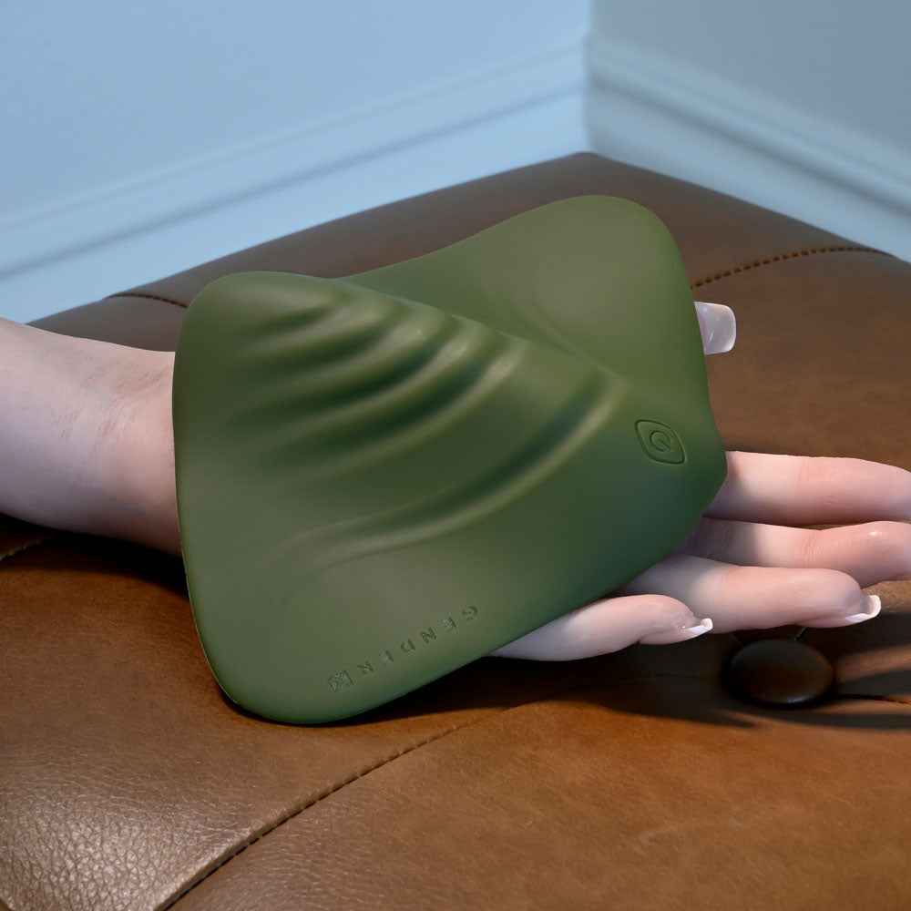 Gender X PLEASURE PAD -  USB Rechargeable Grinding Pad, soft green silicone pleasure pad on a hand.