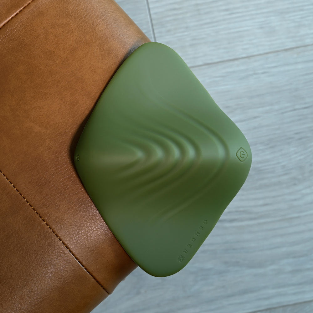 Gender X PLEASURE PAD - USB Rechargeable Grinding Pad displayed on a leather surface.