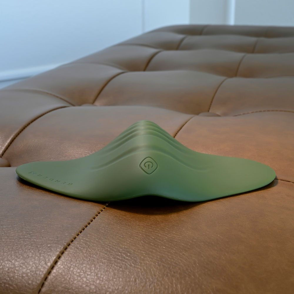 Gender X PLEASURE PAD -  USB Rechargeable Grinding Pad on a leather surface, ready for intimate use.